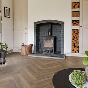 room with log burning fire with oaf effect herringbone flooring