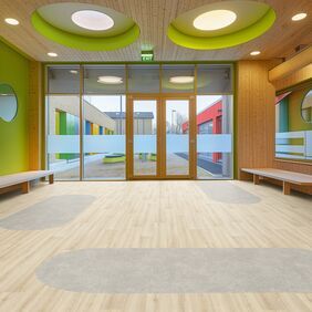Light cement effect flooring laid in a school waiting area