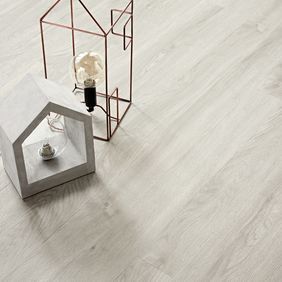 Close up of light wood effect flooring Bianco Oak with lantaren ornaments 