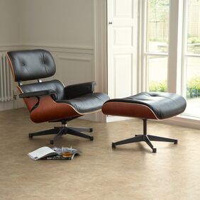 Leather recliner and foot stool next to large floor to ceiling windows featuring stone effect flooring laid in a straight laid design in Classic Yorkstone 