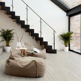 TLC Massimo in New England Assorted Oak laid in living room with two beige beanbags 
