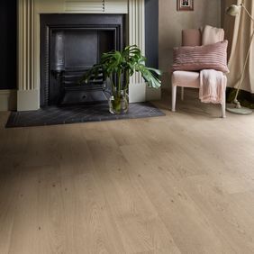 Oak effect flooring in a room with an open fireplace and navy walls