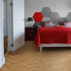 Oak parquet wood effect flooring in a trendy bedroom 