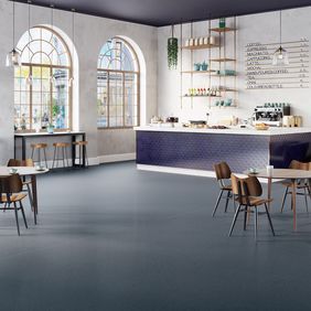 Dark blue safety flooring in a cafe seating area 