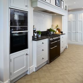 Wood effect flooring in a basket weave style laid in a large kitchen