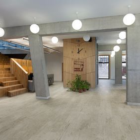 Light concrete effect flooring in a commercial corridor 