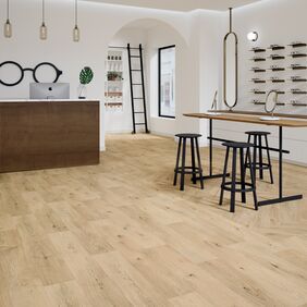 Oak effect flooring laid in a store with parquet style and straight plank
