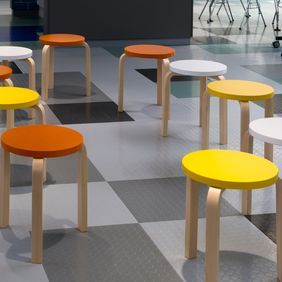 Mixed grey coloured flooring with stools
