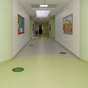 Hospital corridor with light grey and green Polyflor flooring