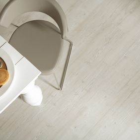 Overhead photo of white wood table with white oak wood pattern flooring