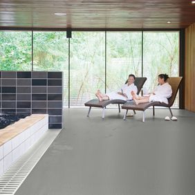 Relaxing area next to swimming pool with loungers