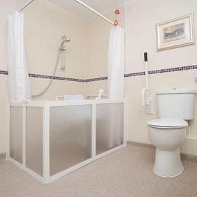 Light coloured safety flooring in a adapted wet room 