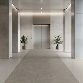 Light cement effect flooring laid in a lift vestibule 