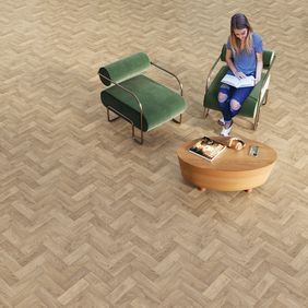 Overhead image of oak effect parquet laid in a seating area with green chairs