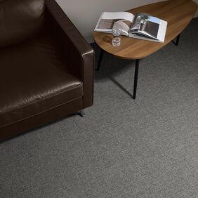 Polyflor Expona Fabrik in Black laid next to a table and chair 