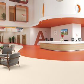 Hospital waiting area with cream and orange design flooring