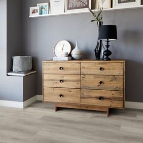 Oak wood draws with home accessories on top featuring light oak effect flooring
