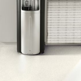 White stone effect flooring in a waiting area with a water cooler