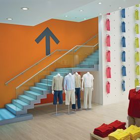 Large clothes store with light oaf effect flooring and orange coloured walls