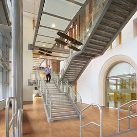 Commercial staircase in an open area with beech effect flooring