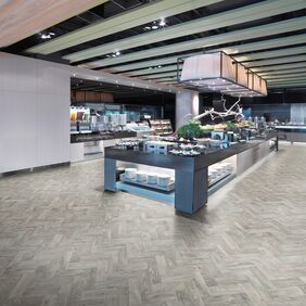 Oak effect flooring laid in a parquet style for a hotel buffet area