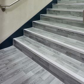 Silver oak wood effect flooring on a staircase in a highschool