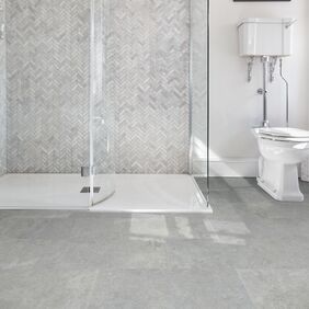 Bathroom, Walk in glass shower, grey tiles, toilet, grey cement style flooring tiles