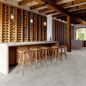 Grey stone stone effect flooring laid in a modern wine cellar