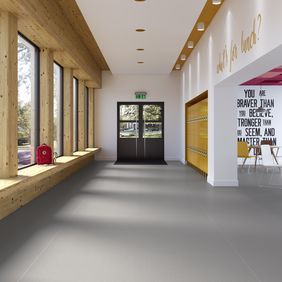 Grey safety flooring in a school corridor