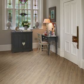 Hallway entrance with dark wood console featuring light wood effect flooring random straight laid in Quayside Oak 