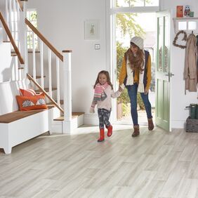 Ash effect flooring laid in an entrance hall with a mother and child