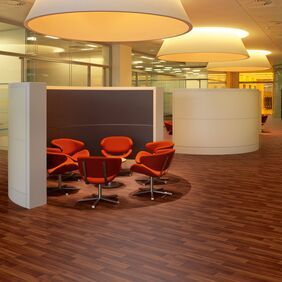 Dark wood effect flooring in a seating hub