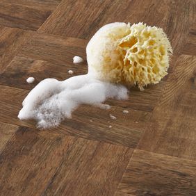 Close up of bathroom with sponge and soapsuds featuring the Georgian Parquet flooring