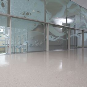 Large hospital corridor with neutral coloured flooring