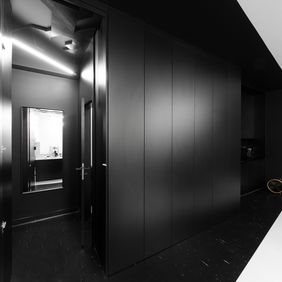Modern office corridor with black flooring