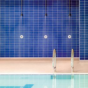 Swimming pool shower area with neutral coloured walkways