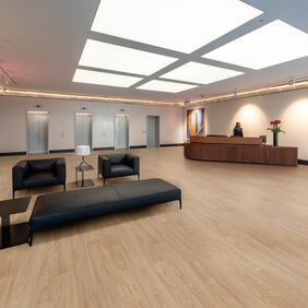 Oak effect flooring laid in an open reception area