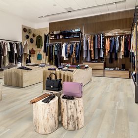 Light oak effect flooring laid in a clothing retail store