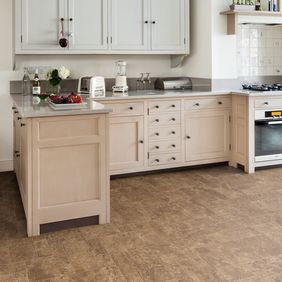 Brown paving effect flooring in a open plan residential kitchen