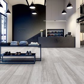 Grey coloured wood effect flooring in a clothing retail store