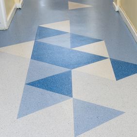 Mixed blue triangle design flooring in a corridor 