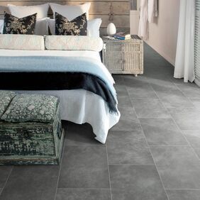 Dark grey slate effect flooring laid in a scandi style bedroom