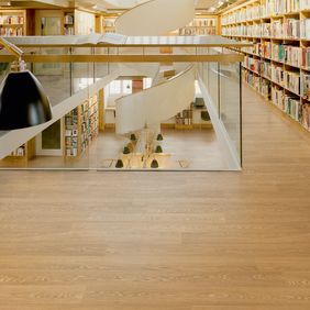 Large library hallway with oak effect flooring