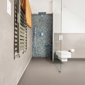 Neutral coloured flooring in a wet room shower area 