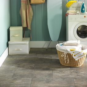 Laundry room featuring slate effect flooring laid in a brickwork design in Ocean Slate using a Graphite Grouting Strip. . 