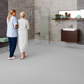 Grey flooring in a large modern wet room 