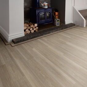 TLC Original in Frosted Driftwood laid by a fireplace