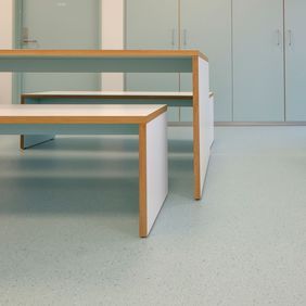 Educational setting seating area with light green coloured flooring