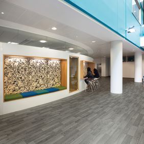 Silver oak wood effect flooring in a highschool breakout area