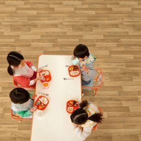 Overhead shot of children sat at a table eating lunch